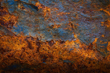 Rusty metal surface with shabby background paint. Blue cracked paint texture on an iron sheet. Fragment of an old metal door, Metal corrosion.