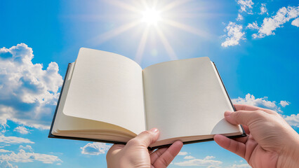 First-person perspective (POV) of hands holding a notebook with empty white pages towards the sun. Sparkling lens flare and fluffy white clouds in a vibrant blue sky create a feeling of hope, learning