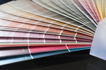 Color swatch fan deck used by designers to choose paint tones and palettes for branding, interiors, and creative projects.