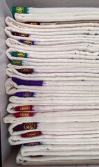 Neatly folded traditional Indian cotton sarees stacked in a store, showcasing textile craftsmanship, fashion retail, and cultural clothing.