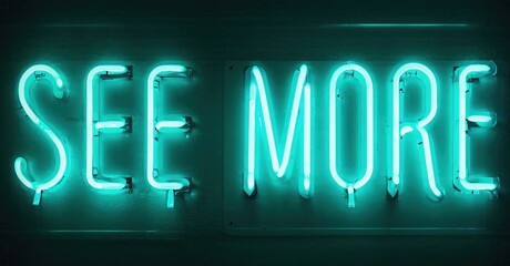 Fototapeta premium Bright turquoise neon sign displays words See More. Dark background emphasizes glowing text. Simple, direct message.