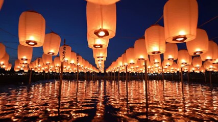 Lantern Festival: Illuminated lanterns cast a warm, inviting glow over a calm lake, their reflections creating a symmetrical display. Evoking a sense of serenity and festive joy.