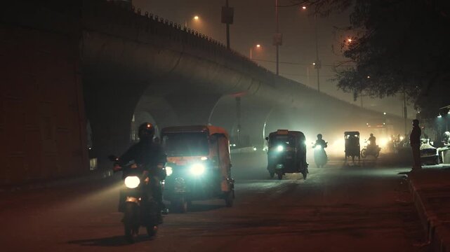 Polluted Winter Night on Delhi Road with Low Visibility and Vehicle Lights