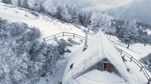 Winter fairytale scenery. wooden huts in deep snow in Alps mountains in Slovenia , Velika Planina plateau. aerial drone footage 4k hd 60 fps 