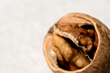 Cracked walnut revealing its rich, golden inside in natural light