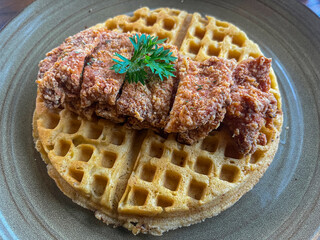 waffles with meat on top, placed on a plate