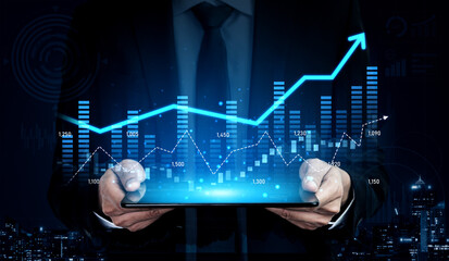 Professional businessman holds a tablet displaying data visualization graphs representing financial growth in a modern night cityscape. Perfect for business and finance themes. Scalp