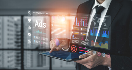 A business professional utilises advanced digital marketing tools and data analytics on a tablet in a modern office setting, showcasing innovative strategies. Gantry