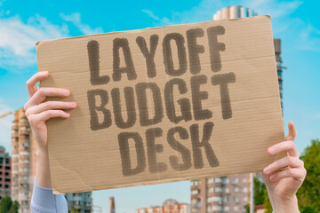 "Layoff Budget Desk" A calm moment where layoff shifts desk and trims layers. OFFICE. ALGORITHM. MANAGER. UPSKILL. BURNOUT.