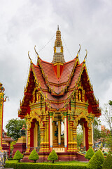 Fototapeta premium Intricately Decorated Thai Temple With Red Roofs, Gold Ornaments, And Elegant Spire Tower Zen Architecture. Wat Bang Thong in Krabi, Thailand