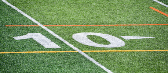 The 10-yard-line of an american football field with artificial turf