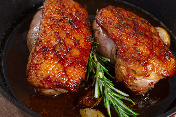 roast duck breast, in a frying pan, with spices and herbs, close-up, no people,