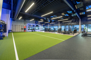 Modern Gym Interior Featuring State-of-the-Art Fitness Equipment and Turf Area