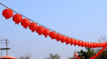 vibrant display of red spherical decorations decorating an outdoor festival under the bright sun