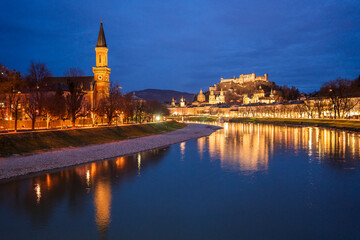 Fototapeta premium Evening view of Salzac River, Salzburg Old town, cathedral and castle in Austria.