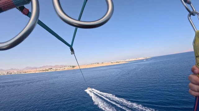 Parasailing Over Red Sea From Point Of View In Slow Motion, Summer Water Sport Adventure Flying On Parachute Behind Boat, Tropical Resort Holiday Travel Experience In Egypt
