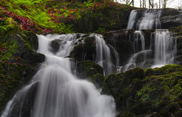The Matxaingo ur-salto waterfall in Areso cascades down rocks and moss. The long exposure turns the...