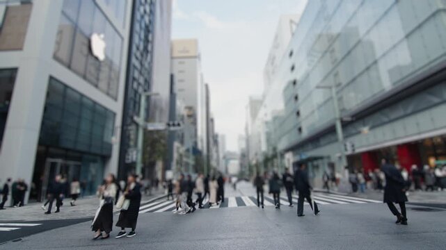 Anonymous crowd of people crossing a street in ginza, tokyo