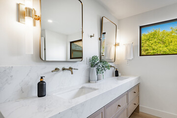 Bright modern bathroom primary powder room sink glass wall shower free standing bath tub white marble granite houseplant rectangle round mirror towel bathrobe clean contemporary