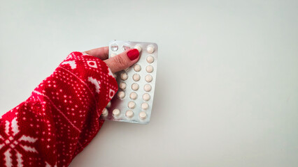 Woman holding blister pack pills