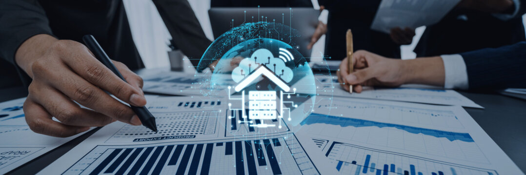 Business professionals collaborate over financial reports, integrating digital cloud technology and data visualization to enhance strategic analysis in the modern office. Trope - Powered by Adobe