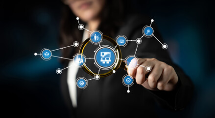 A professional woman interacts with a digital interface showcasing connected nodes, symbolizing technology and innovation in a modern business environment. Tessel