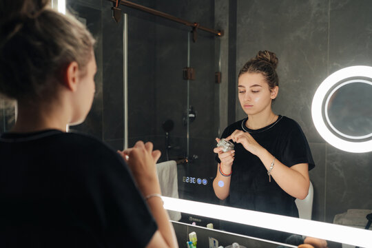 Woman applying moisturizer during her daily skincare routine