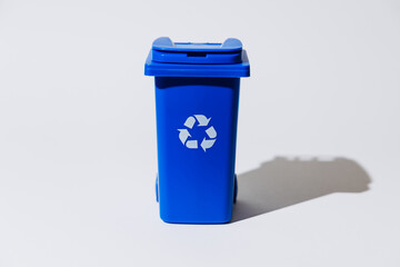 Blue recycling bin with symbol on white background for eco-friendly concept