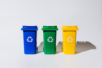 Three color-coded recycle bins arranged in a row, showcasing eco-friendly waste management and promoting recycling awareness for sustainability