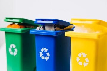 Colorful recycling bins in green, blue, and yellow, showcasing eco-friendly waste management and promoting sustainability in everyday life