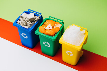 Colorful recycling bins filled with waste materials on a vibrant background, promoting environmental awareness and sustainable practices in waste management