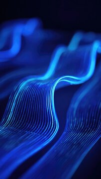 Blue glowing fiber-optic ribbons bending in waves against a dark background Concept Glowing blue fiber-optic ribbons, Ribbons bending in wave patterns, Neon light sculpture against a dark background