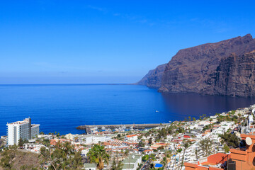 Panorama with vertical cliffs of the Giants (Acantilados de Los Gigantes), townscape of Los Gigantes and Atlantic Ocean at Canary Island Tenerife, Spain