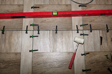 Home improvement. Laying tiles in the  kitchen. Placing ceramic tile on floor. Linear level