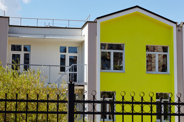 Facade of kindergarten or private school colorful building. Bright building on a sunny day with a blue sky