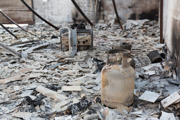 Burnt workshop interior showing fire damage and collapsed roof