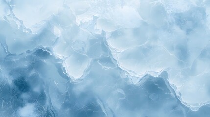 Frozen mountain peaks shrouded in mist and clouds, viewed from a distant vantage point, illustrating a serene winter landscape.