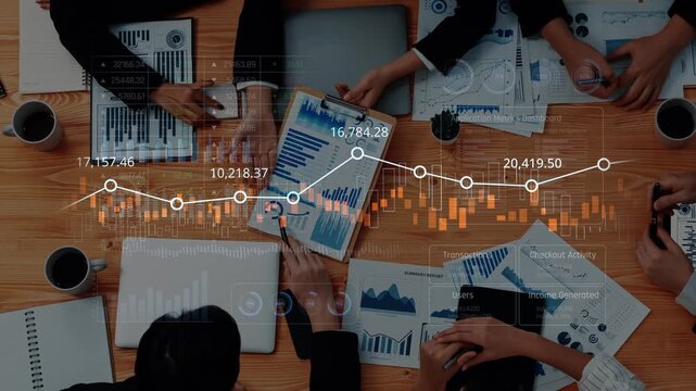 A dynamic business meeting scene featuring professionals engaged in financial analysis, examining charts and trends with laptops and coffee at a modern workspace. Raster