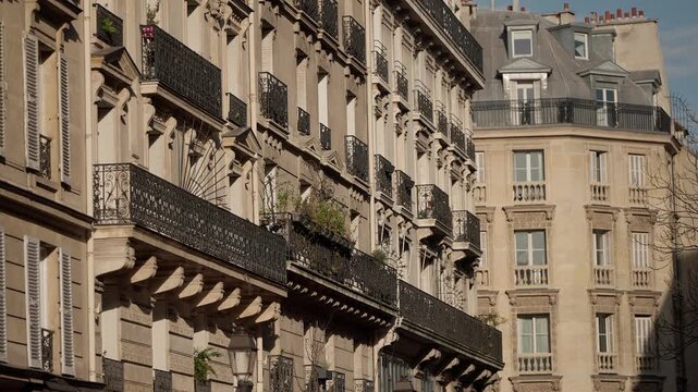 A panning shot showcases the classic Parisian architecture featuring buildings with ornate balconies and windows in Paris France The footage captures the essence of European travel romance and histori