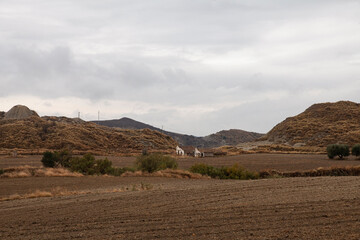 Calanchi are unique white clay "badlands" in Basilicata, Italy, dotted with small patches of farmland. A scenic view of the Teatro dei Calanchi area in autumn.