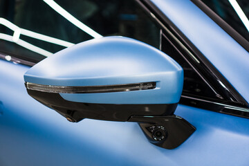 Car side mirror with integrated camera blue car, cam for driver safety and visibility. Car side view camera system integrated into rearview mirror, blind spot detection, 360 visibility. Camera 360. 