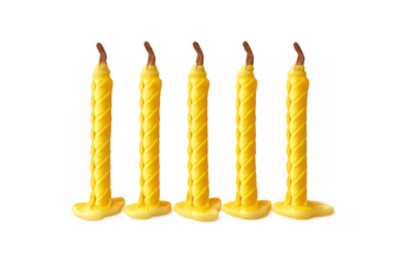 Yellow beeswax candles standing vertically with a distinct twisted texture, wicks ready to light, on a transparent background