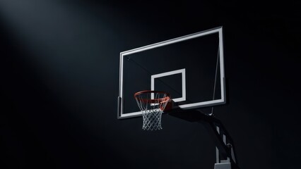 Naklejka premium A basketball hoop stands alone in a dark room with a spotlight shining down on it.
