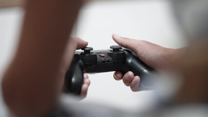 POV boy playing video game with wireless controller in living room - Powered by Adobe