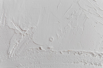 Texture of plaster wall showing detail in the white surface during daylight
