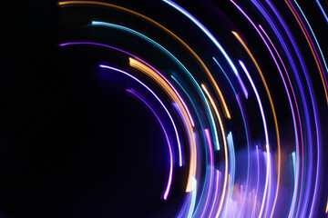 A long exposure photograph. Light painting photography, vibrant fairy lights against a black background
