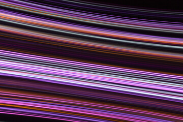 A long exposure photograph. Light painting photography, vibrant fairy lights in parallel lines against a black background