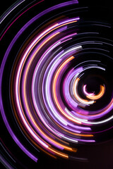 A long exposure photograph. Light painting photography, vibrant fairy lights against a black background