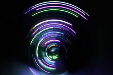A long exposure photograph. Light painting photography, vibrant fairy lights against a black background