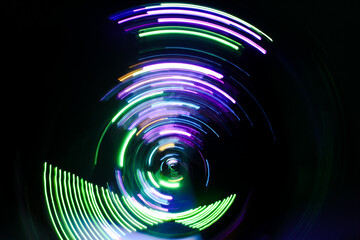 A long exposure photograph. Light painting photography, vibrant fairy lights against a black background